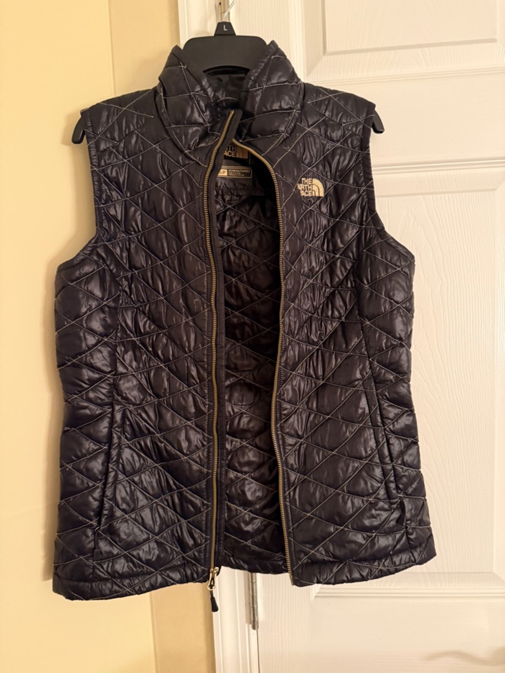The North Face Women's Quilted Vest in Black with Gold Logo
